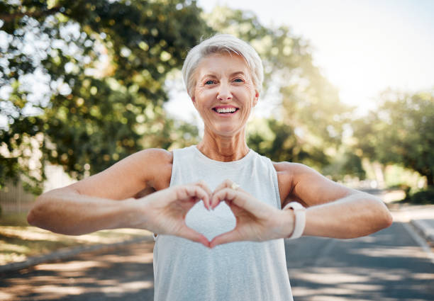Woman making a heart with her hands demonstrating that self-love is very important